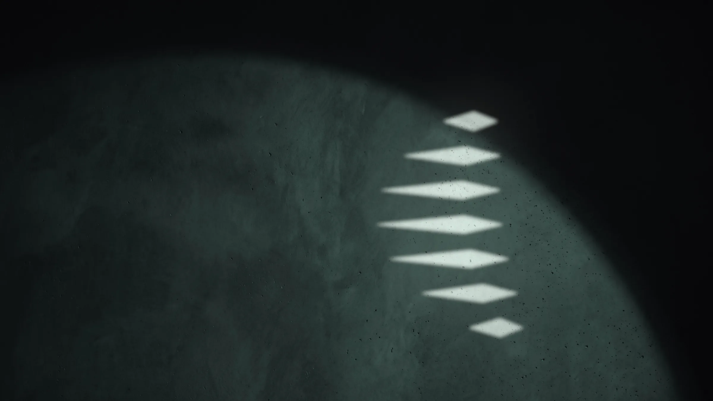 The Figure cast as light on a mineral green sphere