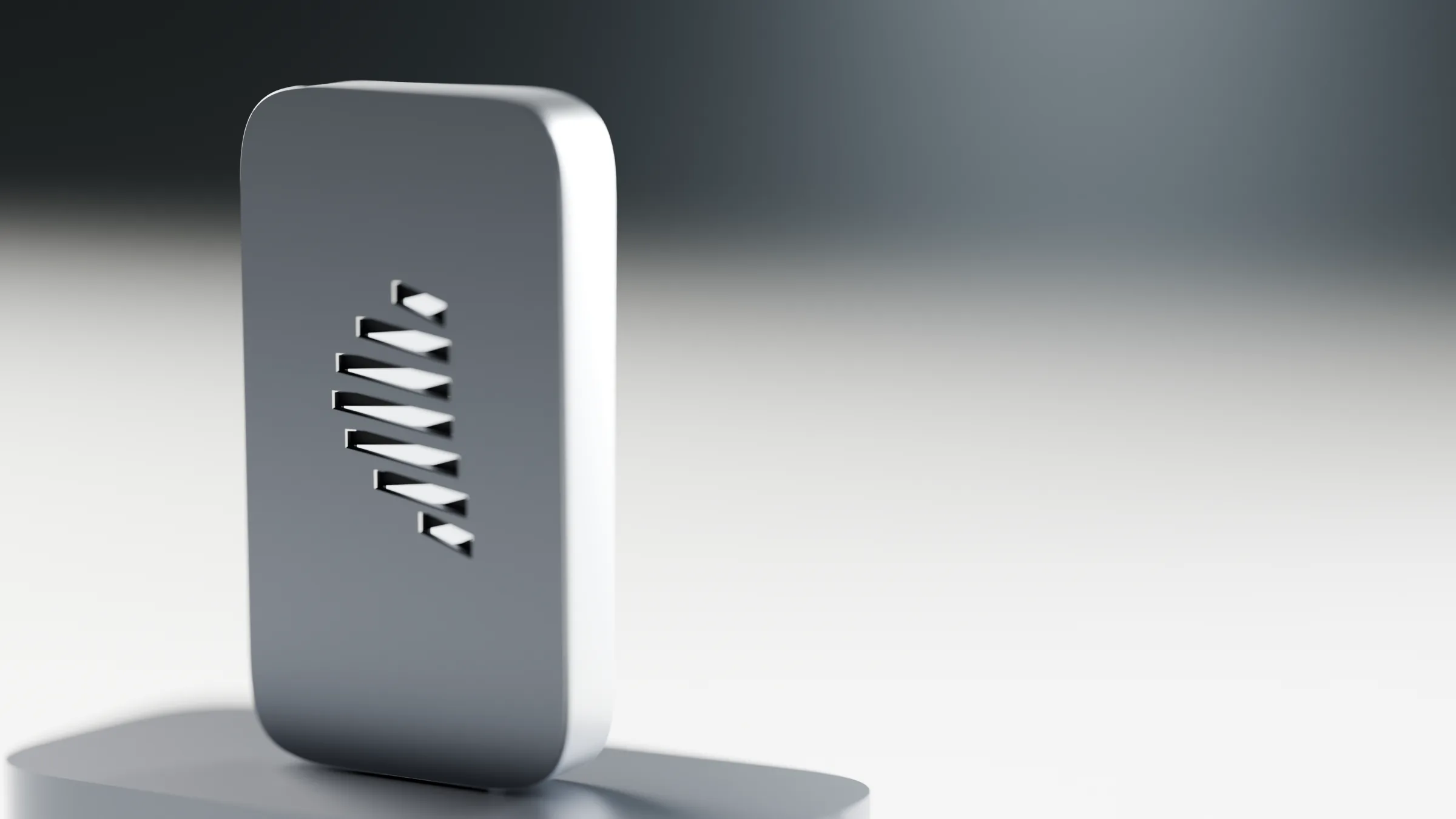 An aluminium key with the Figure cut through it, standing in soft light