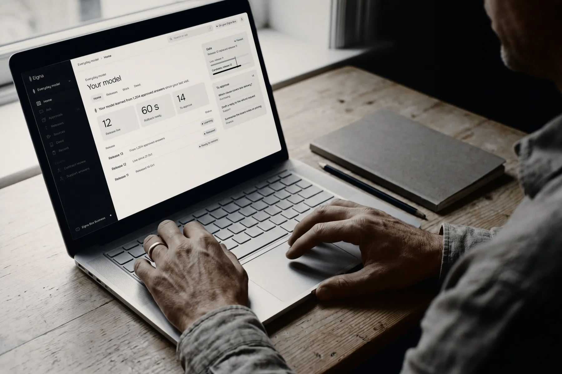 Hands on a laptop, approving an answer in the Eigna app